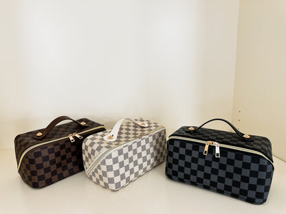 Checkered pattern zippered toiletry cases in brown, white and black